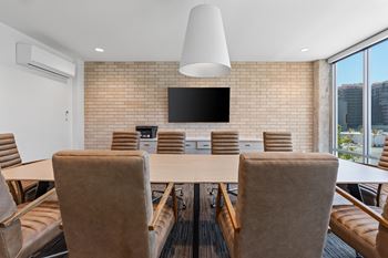 A conference room with a long table and chairs.